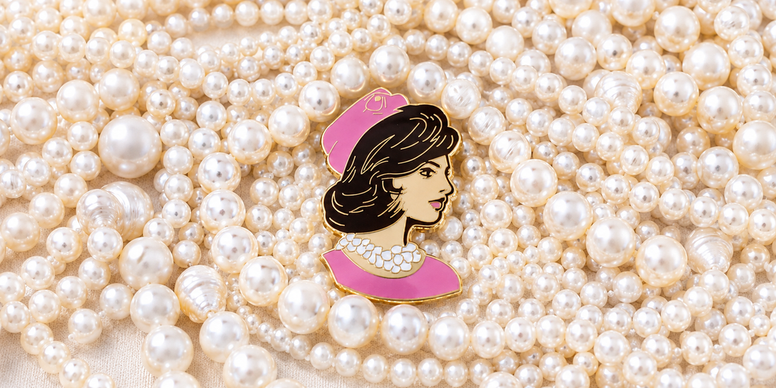 Clutch the Pearls needleminder resting on a strand of pearls