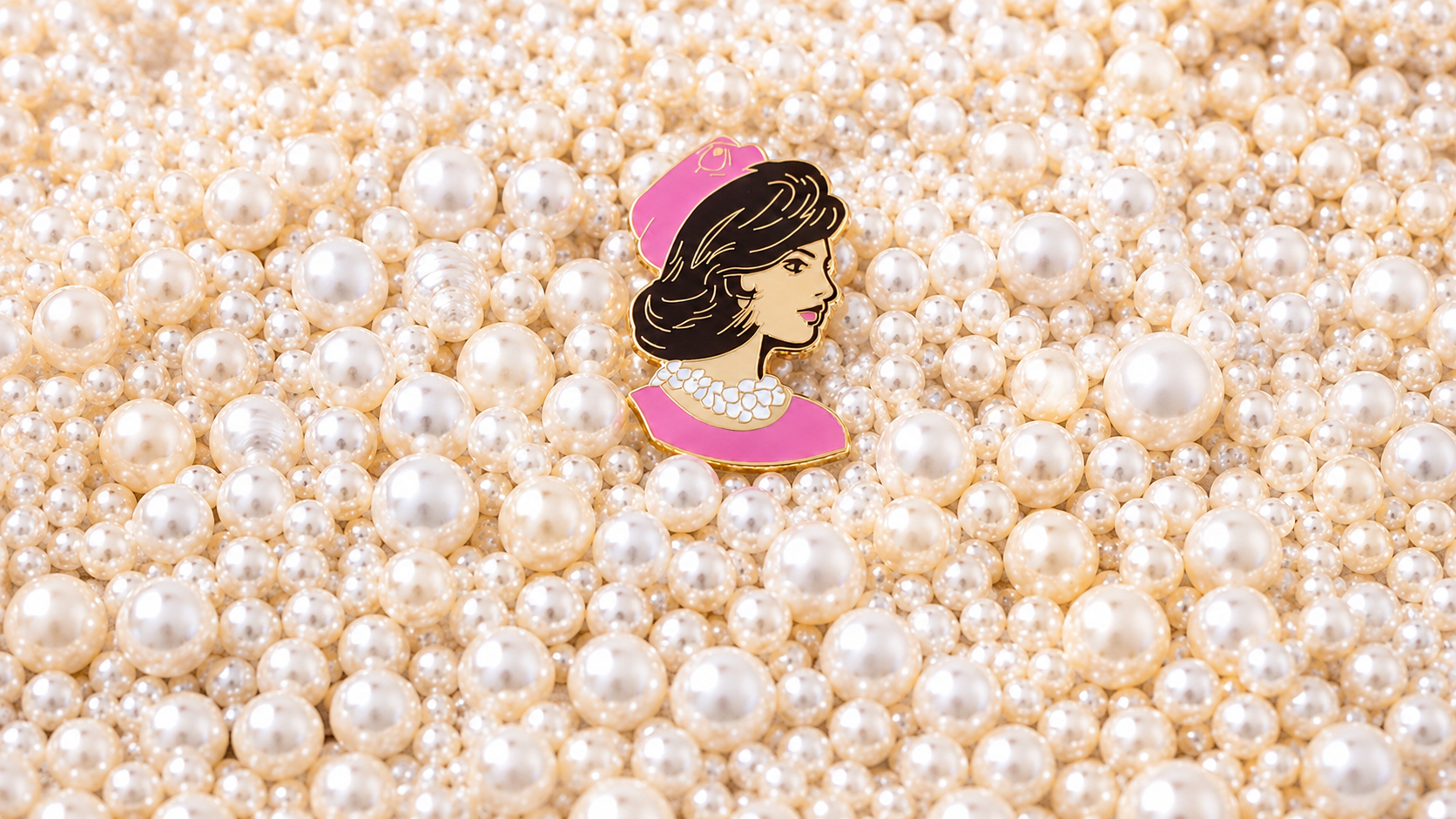 Clutch the Pearls needleminder centered on a bed of pearls