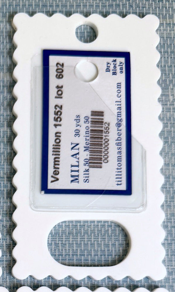 The back of a thread drop, the clear pocket holding the original silk and merino thread tag with its color and lot number
