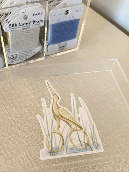 Gold stork scissors sticker on the lid of a thread box